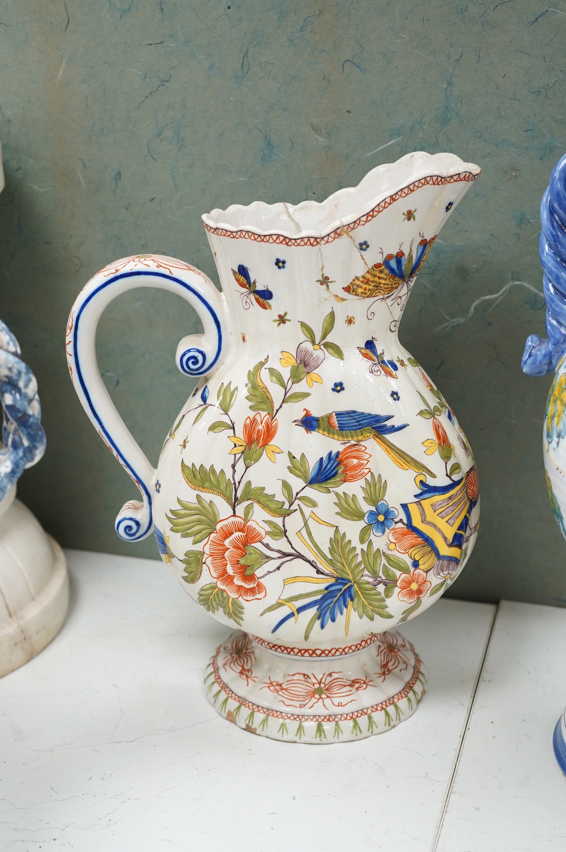 Two large French faience jugs and a vase, and a Talavera twin handled urn/vase, 44cm high